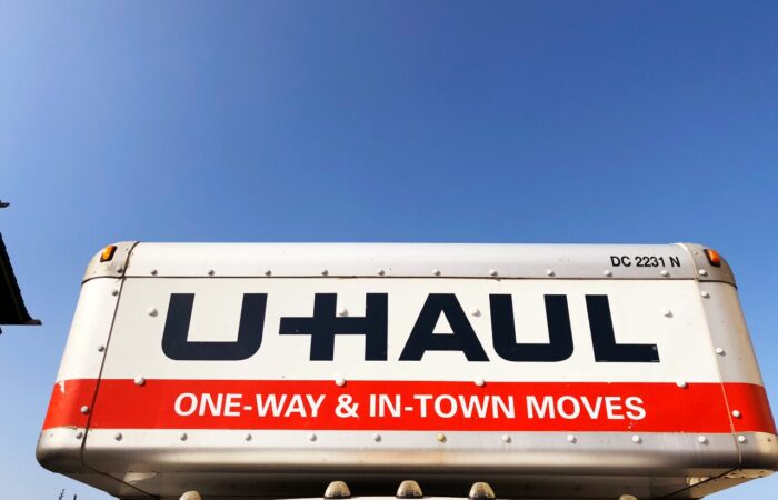 U-Haul overhead storage compartment on a 15’ truck closeup against a blue sky.