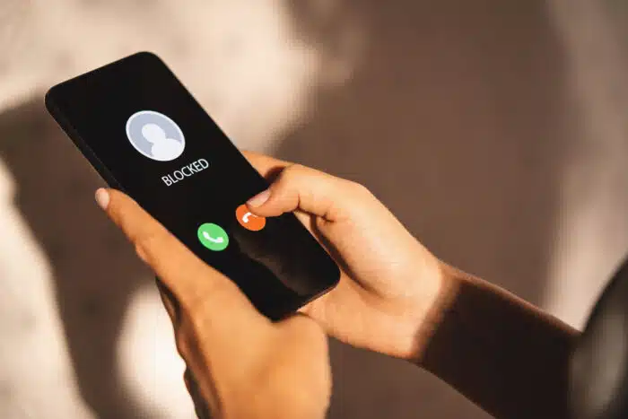 Close up of a woman's hands holding a smartphone receiving a call from an unknown number.