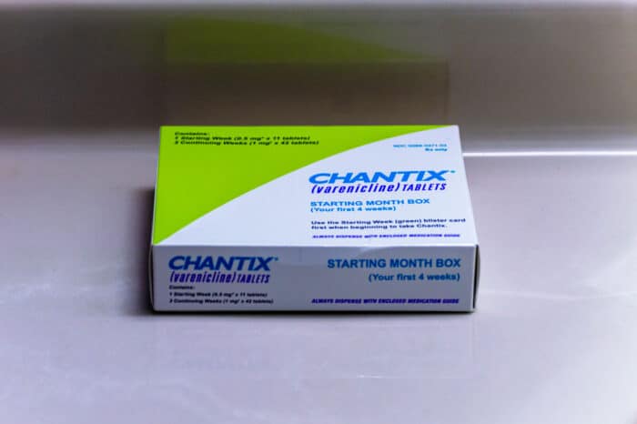 A box of Chantix medication on a counter.