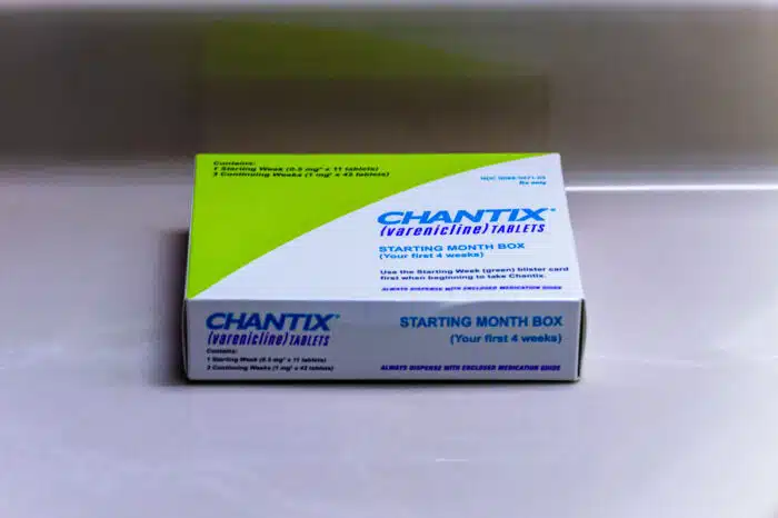A box of Chantix medication on a counter.