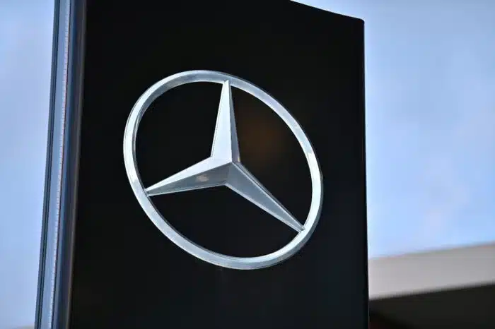 Sign with the logo of German car brand Mercedes-Benz at a dealership