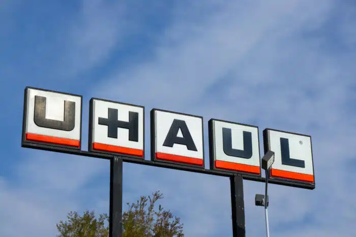 Close up of large U-Haul signage against a blue sky.