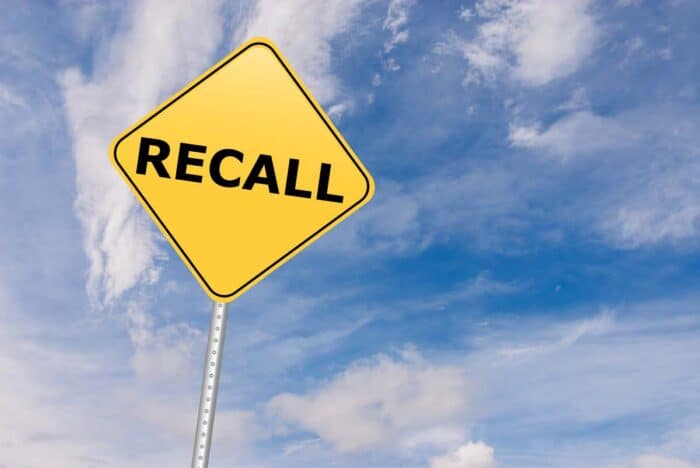Recall Road Sign against sky.