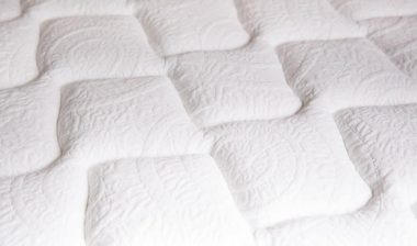 Close up of a pattern on a white mattress.