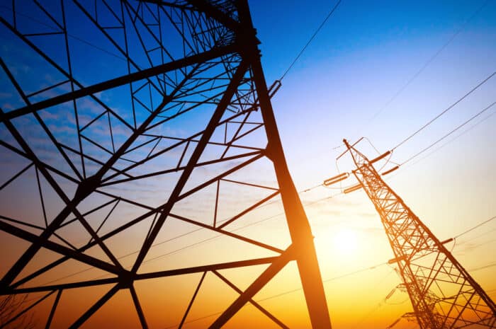 Close up of a high voltage tower against a sunset sky - spark energy lawsuit