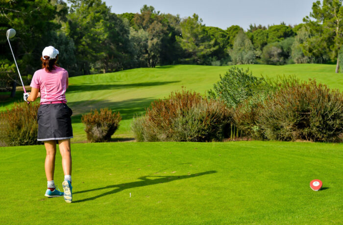 Photo of a woman playing golf.