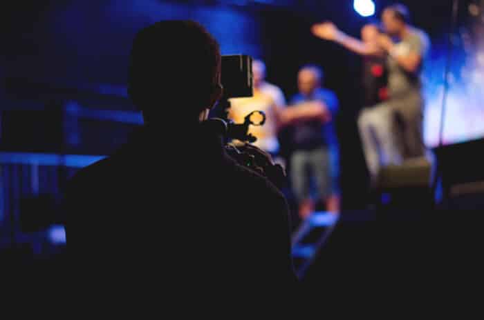 Back view of a student recording a play on a video camera - Studio 4, James Franco, tuition settlement