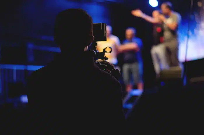 Back view of a student recording a play on a video camera - Studio 4, James Franco, tuition settlement