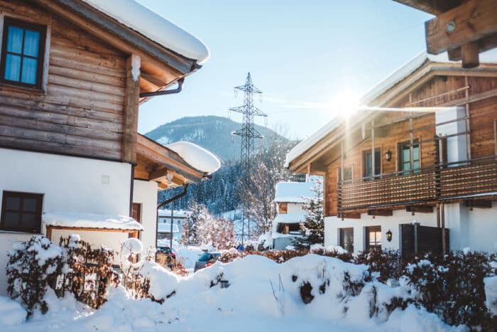 A ski resort with snow on the ground and a sunny sky - Ikon Pass refunds class action lawsuit settlement
