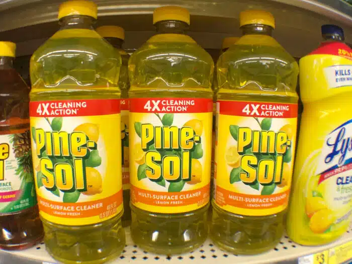 Close up of Pine-Sol bottles on a supermarket shelf.