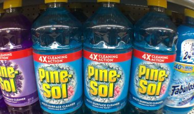 Close up of Pine-Sol bottles on a grocery store shelf.