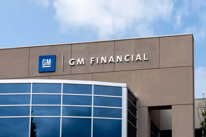 GM signage on exterior of building against a blue sky.