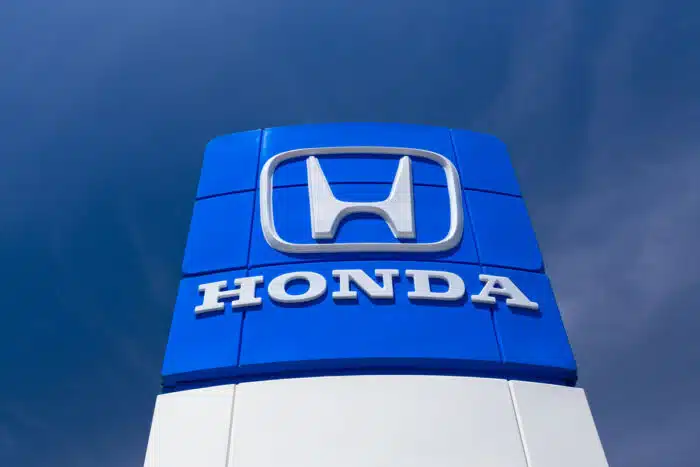 Honda automobile dealership Sign against a dark blue sky.