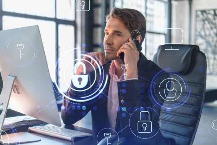 A businessman talking on the phone with a biometric data overlay.