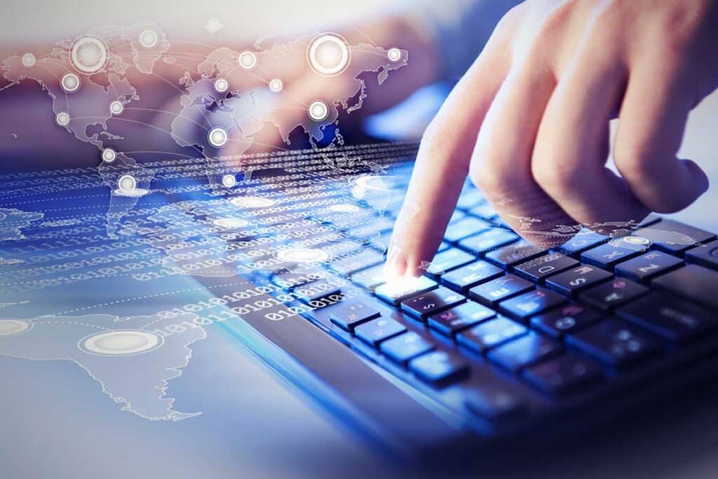 Close up of a hand pushing a key on a keyboard with a data concept overlay, representing the Faneuil data breach class action lawsuit settlement.