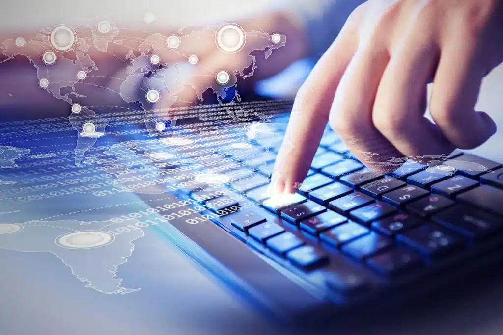 Close up of a hand pushing a key on a keyboard with a data concept overlay, representing the Faneuil data breach class action lawsuit settlement.
