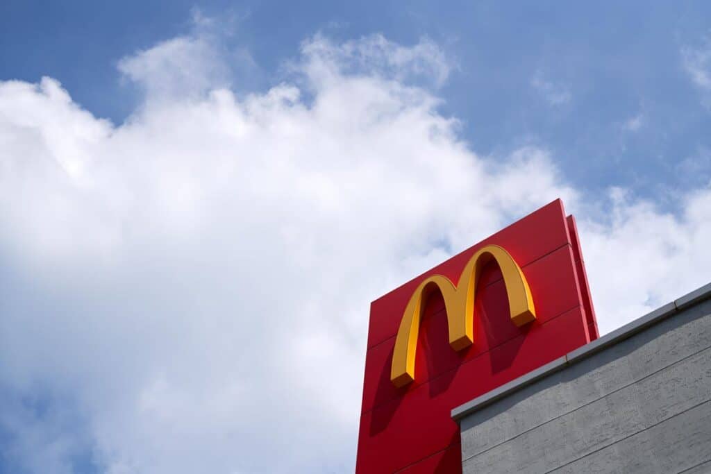 Close up of McDonalds signage against a bright blue sky - McDonald's lawsuit, pork price fixing