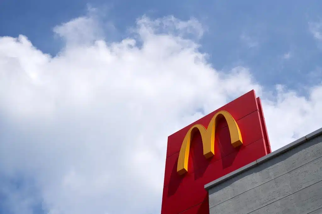 Close up of McDonalds signage against a bright blue sky - McDonald's lawsuit, pork price fixing