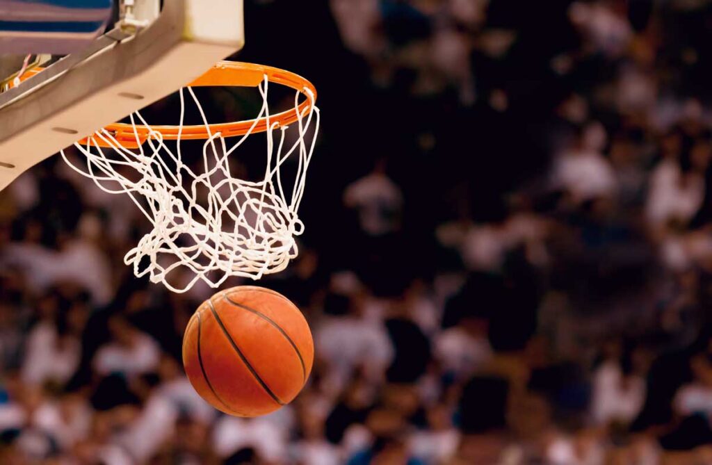 Close up of a basketball going through a basketball hoop - Irving suspension
