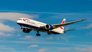 A British Airways plane in flight in the sky.