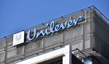 Close up of Unilever signage against a blue sky.
