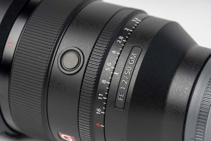 Close up of a Sony camera lens against a white background - Sony class action