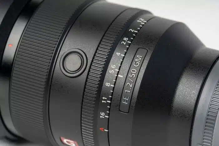 Close up of a Sony camera lens against a white background - Sony class action