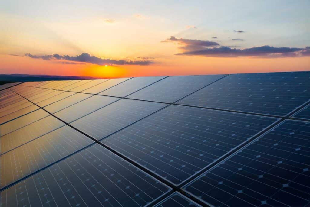 Close up of solar panels against a sunset sky, representing the LGCY Power employee misclassification class action lawsuit settlement.