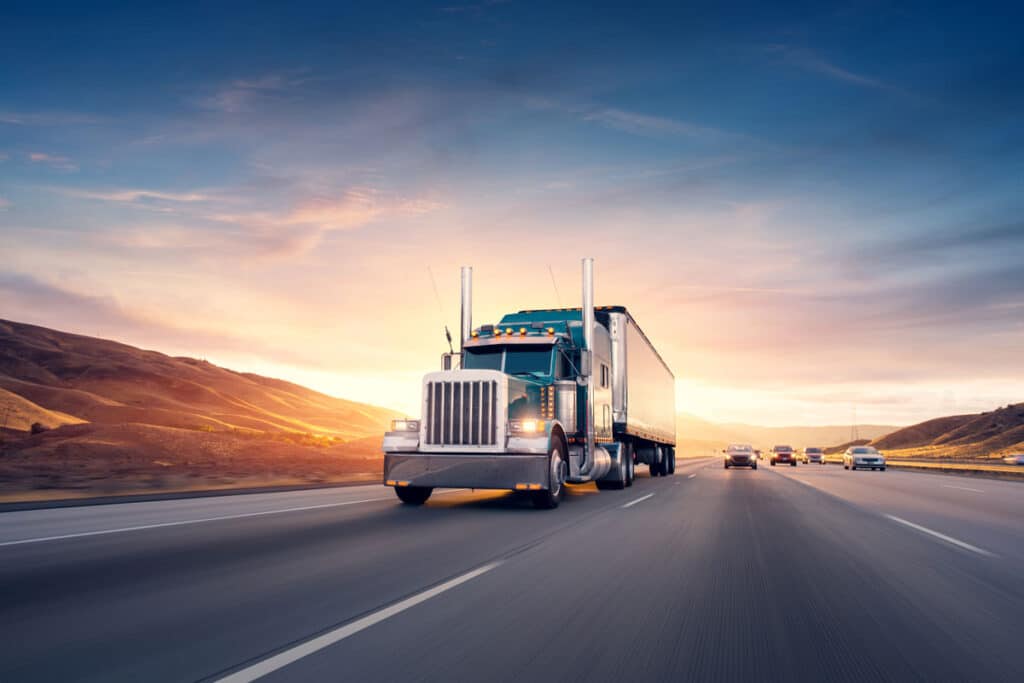 American style truck on freeway pulling load against a sunset sky, representing the Experior Transport, Polmax LLC settlement.