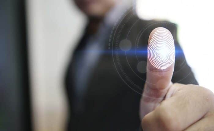 Businessman with a fingerprint overlay, representing the Ron's Staffing fingerprint time clock settlement
