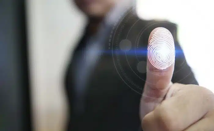 Businessman with a fingerprint overlay, representing the Ron's Staffing fingerprint time clock settlement