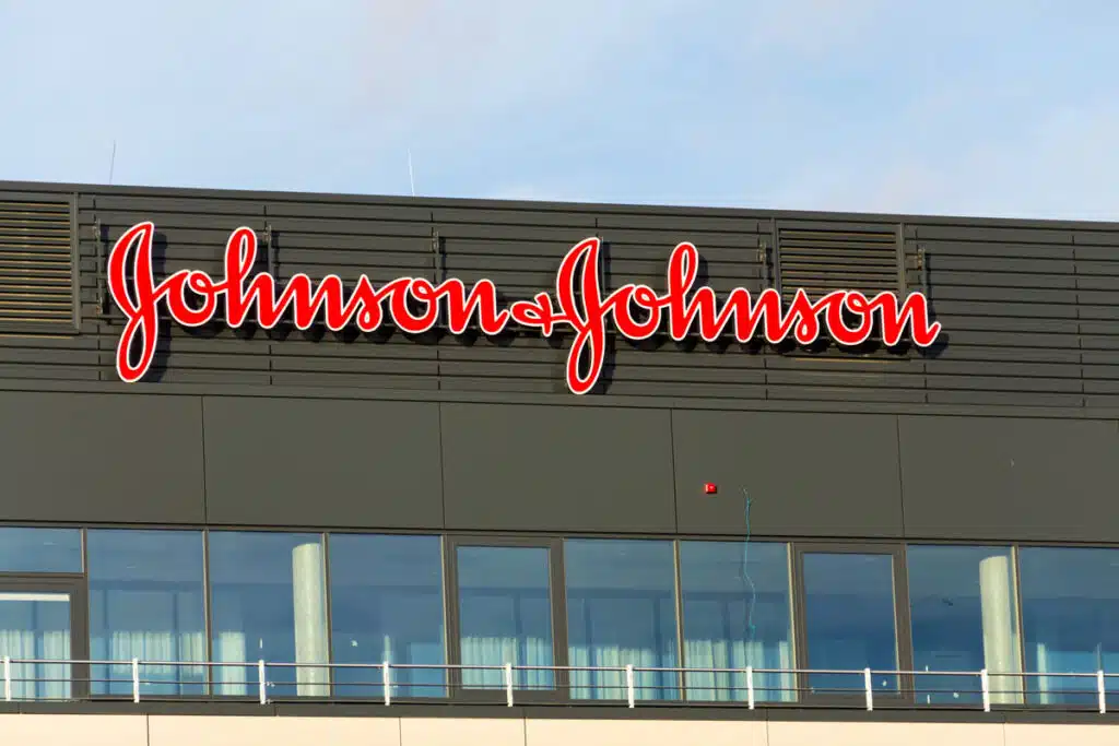Johnson & Johnson company logo on headquarters building against a blue sky.