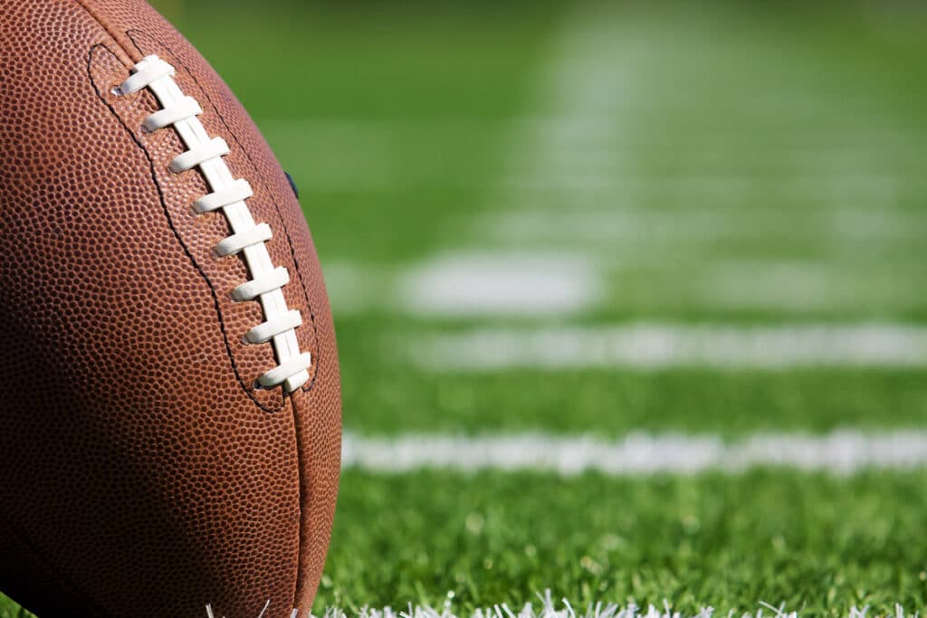 Close up of a football on a football field.