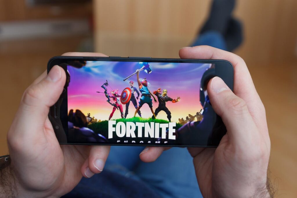 Close up of Fortnite logo on a smartphone screen.