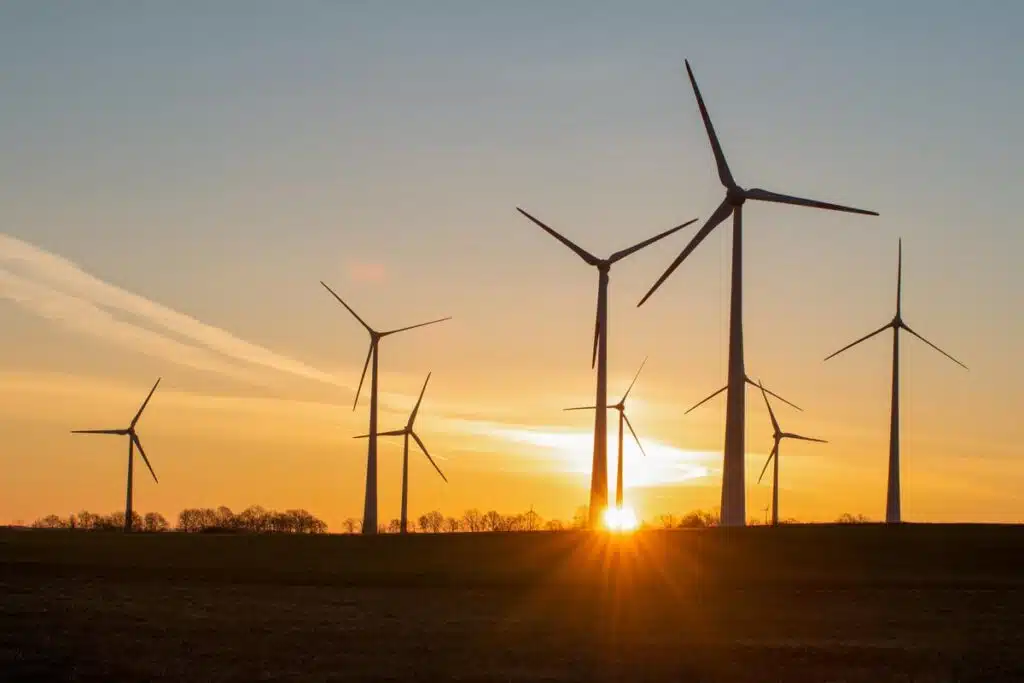 Wind turbines against a sunset sky.