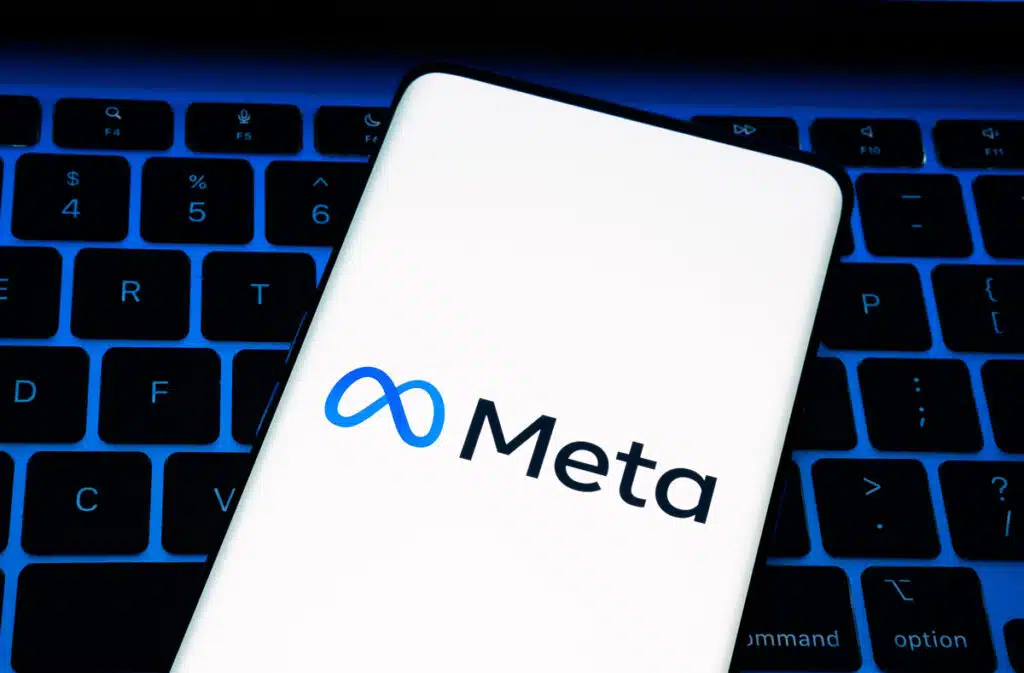 company logo seen smartphone which is placed on laptop keyboard - Meta class action, tax information