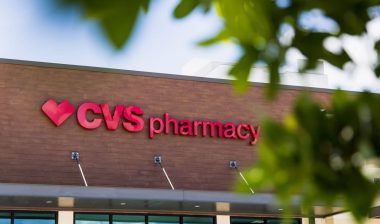 A CVS Pharmacy overlooks an empty parking lot on a hot summer day.