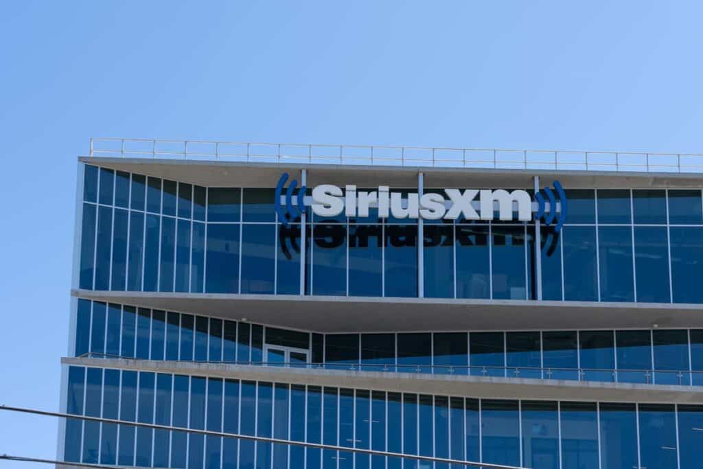 Close up of SiriusXM signage on a building against a blue sky.