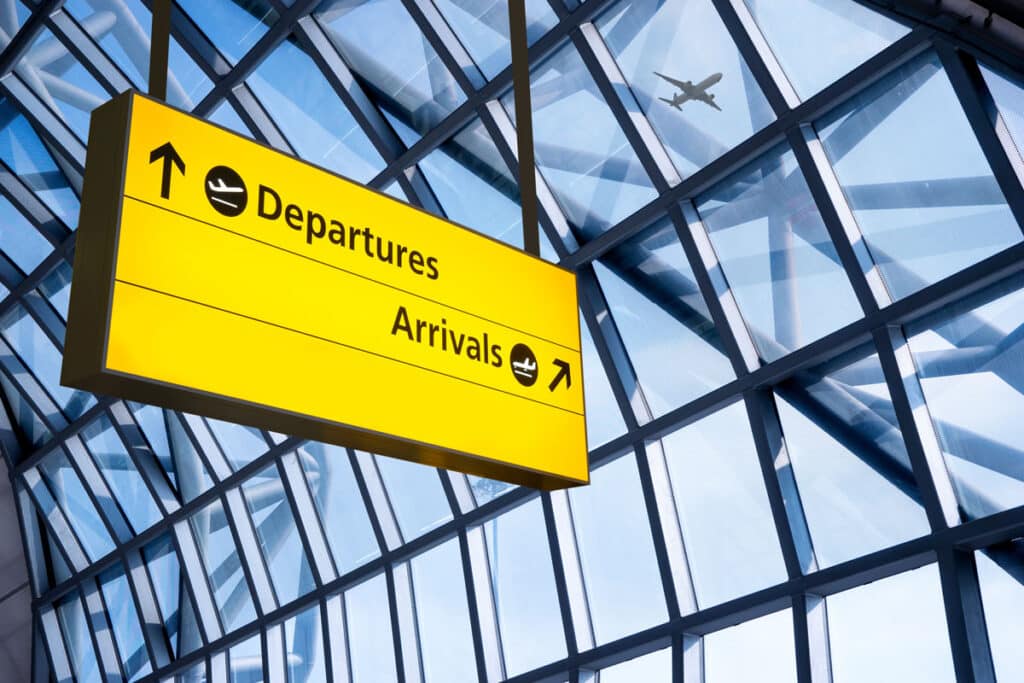 Close up of Airport Departure & Arrival information board sign - American Airlines and JetBlue class action