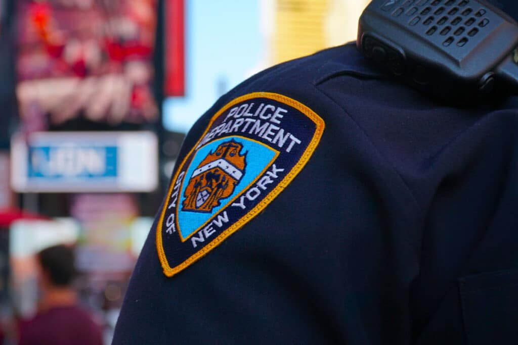 NYPD sleeve patch shield on a police officer.