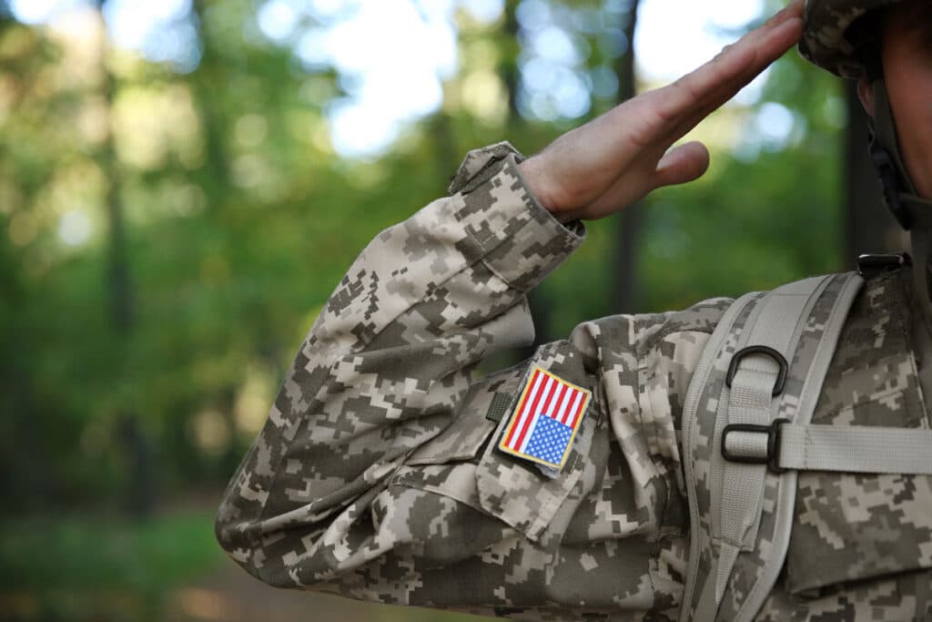 Soldier in camouflage taking salute, close up view.
