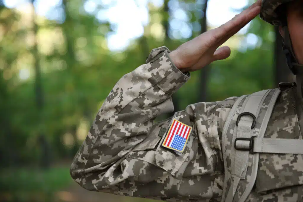 Soldier in camouflage taking salute, close up view.