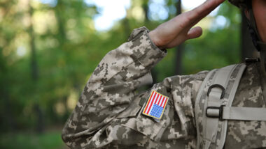 Soldier in camouflage taking salute, close up view.