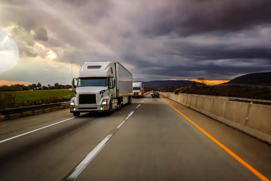 Close up of white semi traveling along a highway, representing the C&K Trucking settlement - owner operator