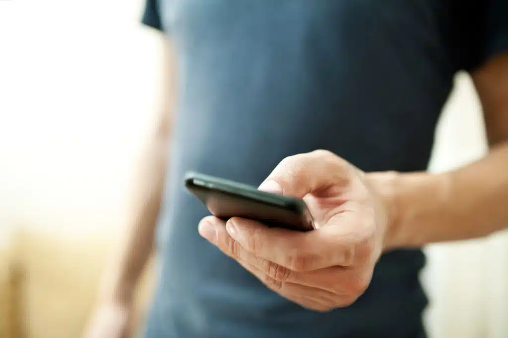 Close up of a man using mobile smart phone.