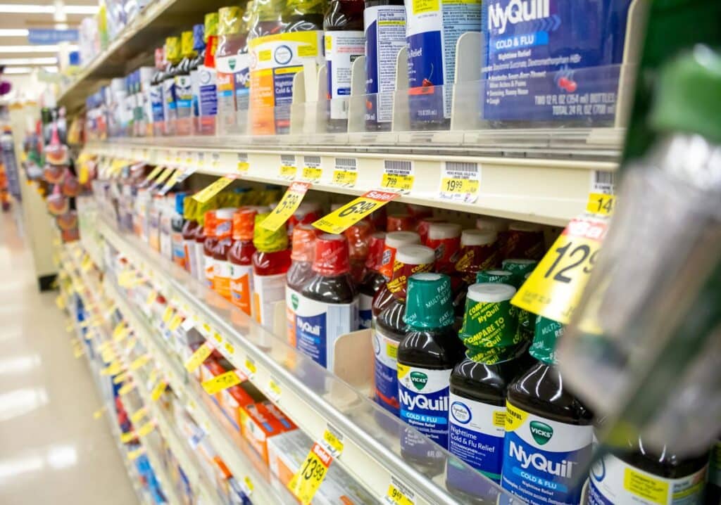 Close up of over the counter medicine on a grocery store shelf, representing medicine class action lawsuits.