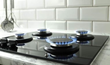 Closeup shot of blue fire from domestic kitchen stove top.