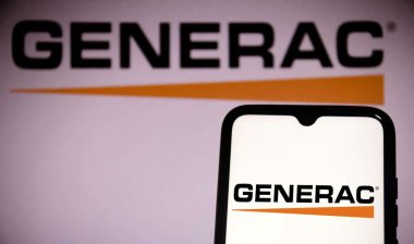 Generac Holdings logo seen on a smartphone screen and in the background.