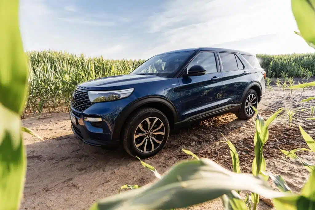 A dark blue Ford Explorer in a field.