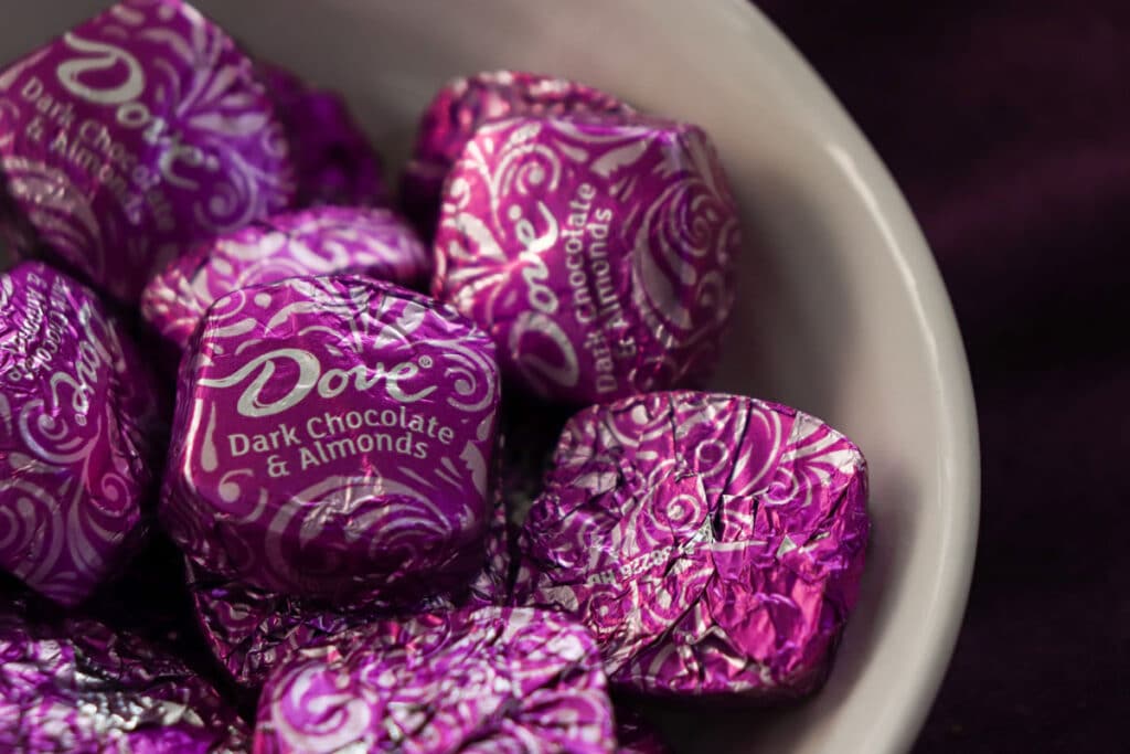 Closeup of individually wrapped and covered Dove Dark Chocolate and Almonds.